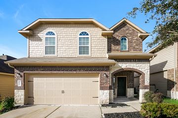 Houston apartment for rent - a tan brick house with a white garage door