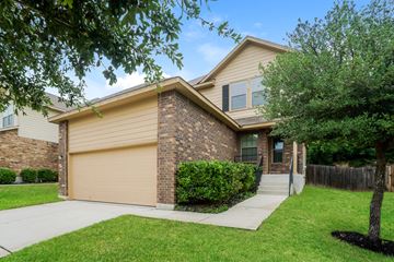 Houston apartment for rent - a tan and brown house with a sidewalk in front of it