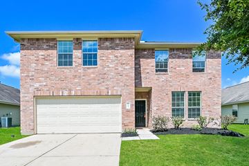 Houston apartment for rent - a large brick house with a white garage door