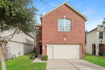 Houston apartment for rent - a red brick house with a white garage door