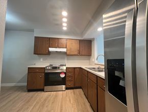 Fort Collins apartment for rent - a kitchen with wooden cabinets and stainless steel appliances