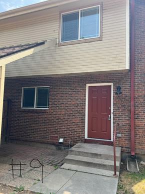 Fort Collins apartment for rent - the front of a brick house with a red door