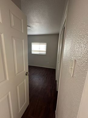 San Bernardino apartment for rent - a room with a door and a window and a hallway