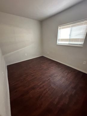 San Bernardino apartment for rent - an empty room with wooden floors and a window