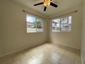 Honolulu apartment for rent - A room with a ceiling fan and two windows.