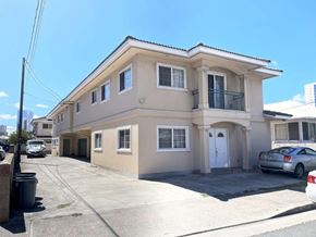 Honolulu apartment for rent - A two-story house with a garage and a car parked in front.