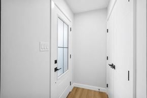 Calgary apartment for rent - a bedroom with white walls and a door with a window