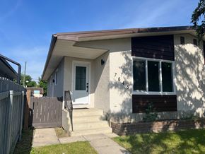 Calgary apartment for rent - the front of a house with steps and a fence