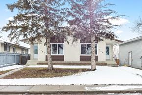 Calgary apartment for rent - front of house with trees in the front yard