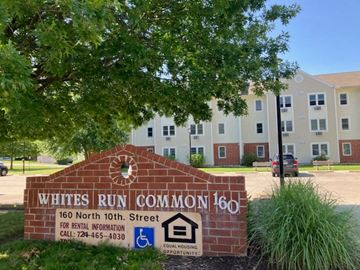 Indiana apartment for rent - a sign for the white run common 160 in front of an apartment building