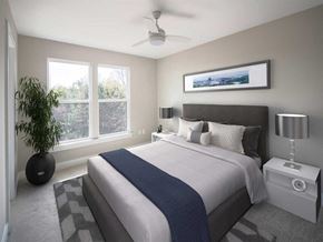Dulles apartment for rent - A bedroom with a large bed and a ceiling fan.