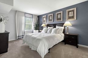 Rockville apartment for rent - bedroom with blue walls and a white bed