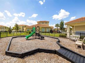 Port St. Lucie apartment for rent - A playground with a green slide and a black railing.