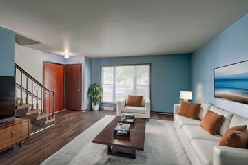 Madison house for rent - A living room with a white couch and a brown coffee table.