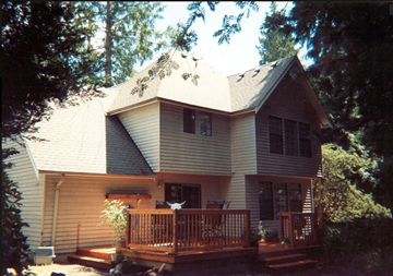 Bothell house for rent - A house with a grey roof and a brown deck.