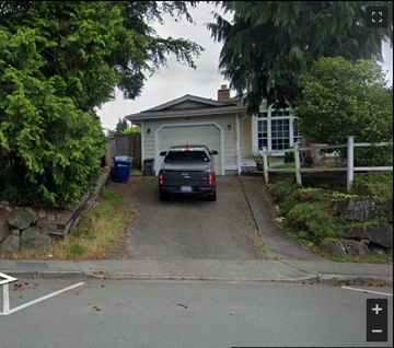 Bothell house for rent - A car is parked in front of a garage.