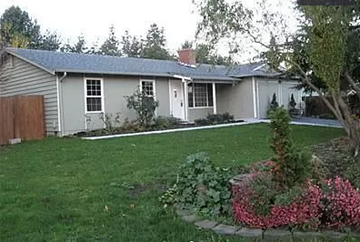 Bothell house for rent - a white house with a lawn and a garden