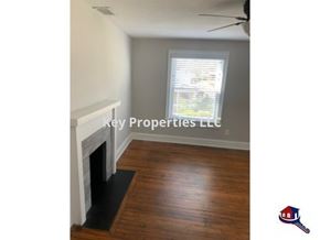 Knoxville house for rent - A room with a fireplace and a window with blinds.