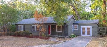 Jackson house for rent - a small gray house with a front yard and trees
