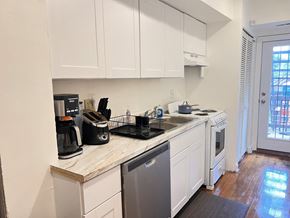 Washington apartment for rent - a kitchen with white cabinets and a sink and a dishwasher