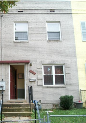 Washington apartment for rent - a white brick house with two windows and steps