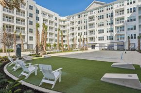 Tampa apartment for rent - A white building with a green lawn in front.