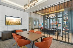 Tampa apartment for rent - A conference room with a long table and orange chairs.
