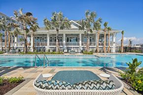 Tampa apartment for rent - A pool area with a wicker chair and a pool table.