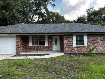 Deridder house for rent - A small brick house with a white door and windows.