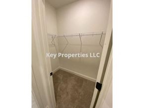 Loudon house for rent - A hallway with a carpeted floor and a sign that says Key Properties LLC.