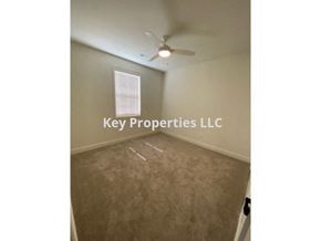 Loudon house for rent - A room with a fan and a sign that says Key Properties LLC.