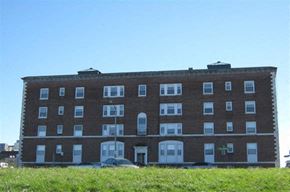 Worcester apartment for rent - a large brick building with cars in front of it