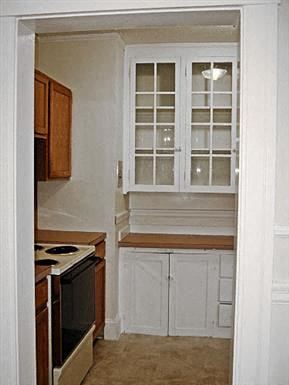 Worcester apartment for rent - a small kitchen with a stove and a window