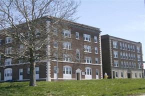 Worcester apartment for rent - a large brick building with a tree in front of it
