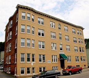 Worcester apartment for rent - a large brick building with cars parked in front of it