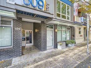 Seattle apartment for rent - Street level entrance to 509 1st with brick detailing and large storefront windows in Seattle.
