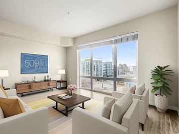 Seattle apartment for rent - a living room with white furniture and a large window