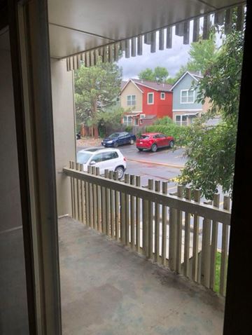 Boulder apartment for rent - A view from a window of a red car parked in a driveway.
