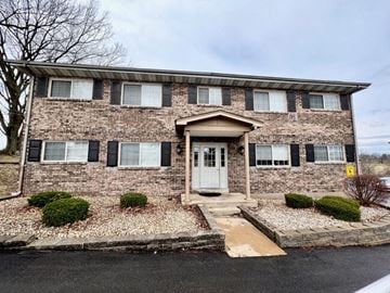 St. Louis apartment for rent - the front of a brick house with a white door