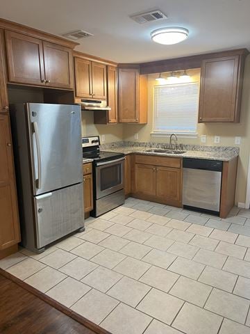Cleveland apartment for rent - a kitchen with wooden cabinets and a stainless steel refrigerator