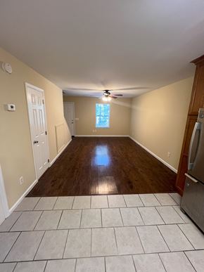 Cleveland apartment for rent - an empty living room with wooden floors and a ceiling fan