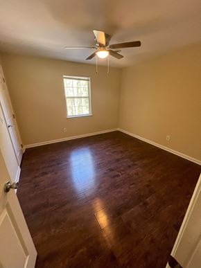 Cleveland apartment for rent - a empty room with a ceiling fan and wood floors