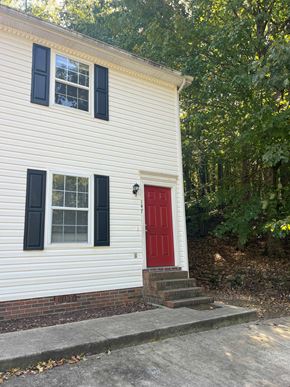 Cleveland apartment for rent - a red door on the side of a white house