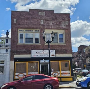 Jersey City apartment for rent - A red car is parked in front of a building with a sign that reads "VANO ITALIAN BREAD".
