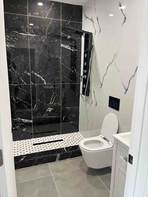 Brooklyn apartment for rent - a black and white bathroom with a toilet and shower