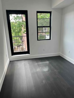 Brooklyn apartment for rent - an empty room with a window and wooden floors