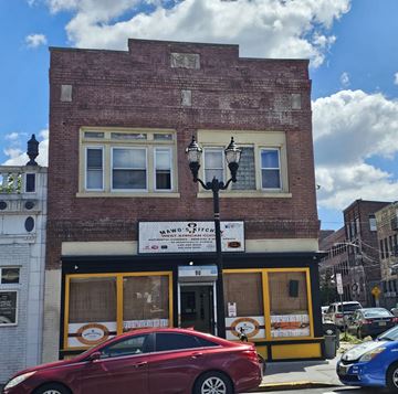 Jersey City apartment for rent - A red car is parked in front of a building with a sign that says "VANO ITALIAN".