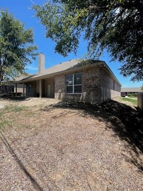 Temple house for rent - a brick house with a gravel yard and trees