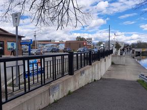 Chesterville apartment for rent - A sidewalk runs alongside a body of water with a sign that reads 50.
