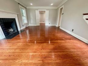 Louisville house for rent - a living room with a wooden floor and a fireplace